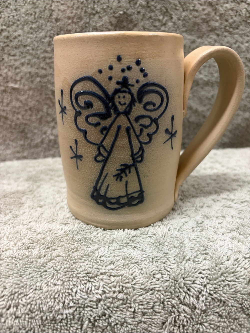 Handcrafted Tan Ceramic Mug with Navy Angel Motif